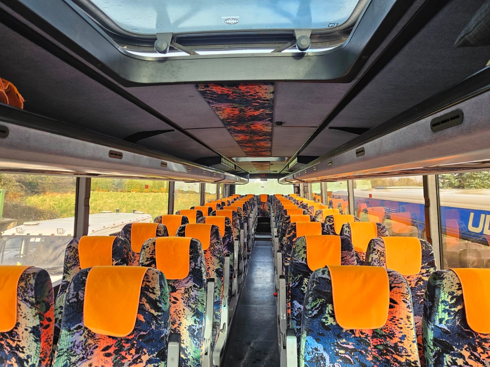 Interior of the large coach with orange seats